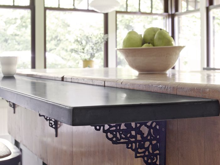 Mounted breakfast bar with brown countertop.