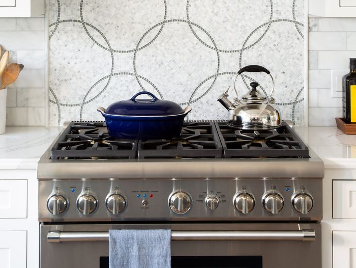 A pot and kettle on a clean kitchen stovetop