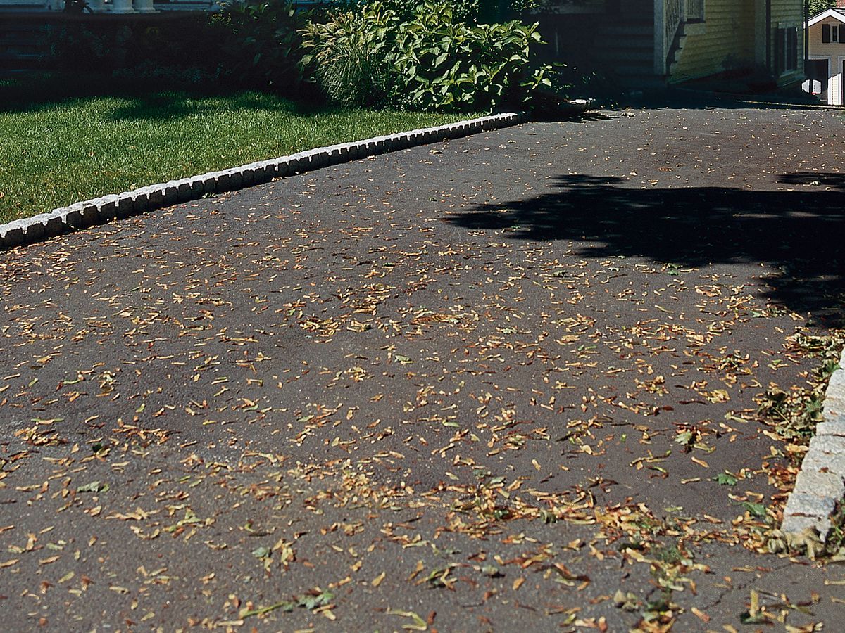 A belgian brick driveway leading up to a house