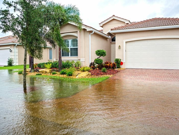 Photo of a flood encroaching on a home. Preparing for a flood can prevent your house from damage.