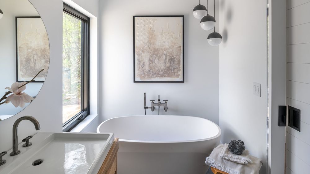 A small bathroom with a bathtub and sliding barn door