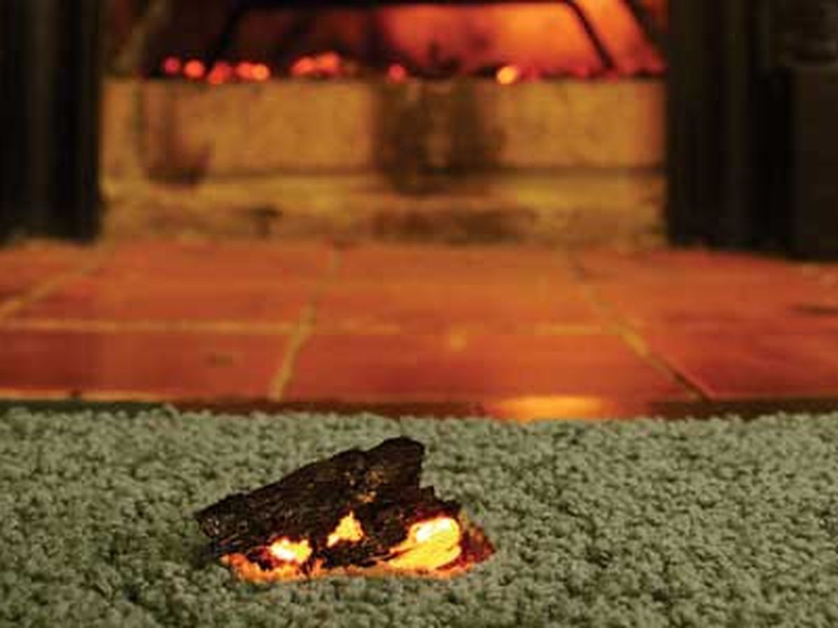 Carpet with a burn mark that can be fixed with a carpet patch.